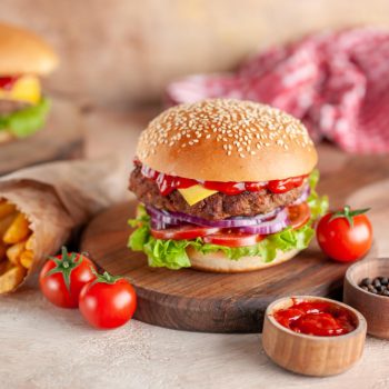front-view-yummy-meat-cheeseburger-with-french-fries-cutting-board-light-background-salad-dinner-snack-fast-food-dish-burger