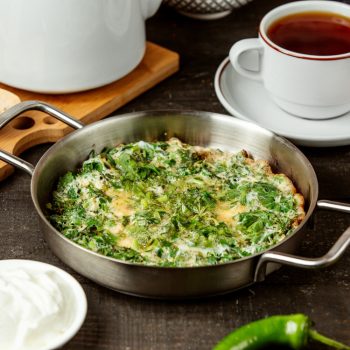 side-view-azerbaijani-traditional-kuku-fried-eggs-with-herbs-pan