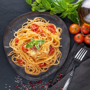tasty-appetizing-classic-italian-spaghetti-pasta-with-tomato-sauce-cheese-parmesan-basil-plate-ingredients-cooking-pasta-dark-table-flat-lay-top-view-copy-spce